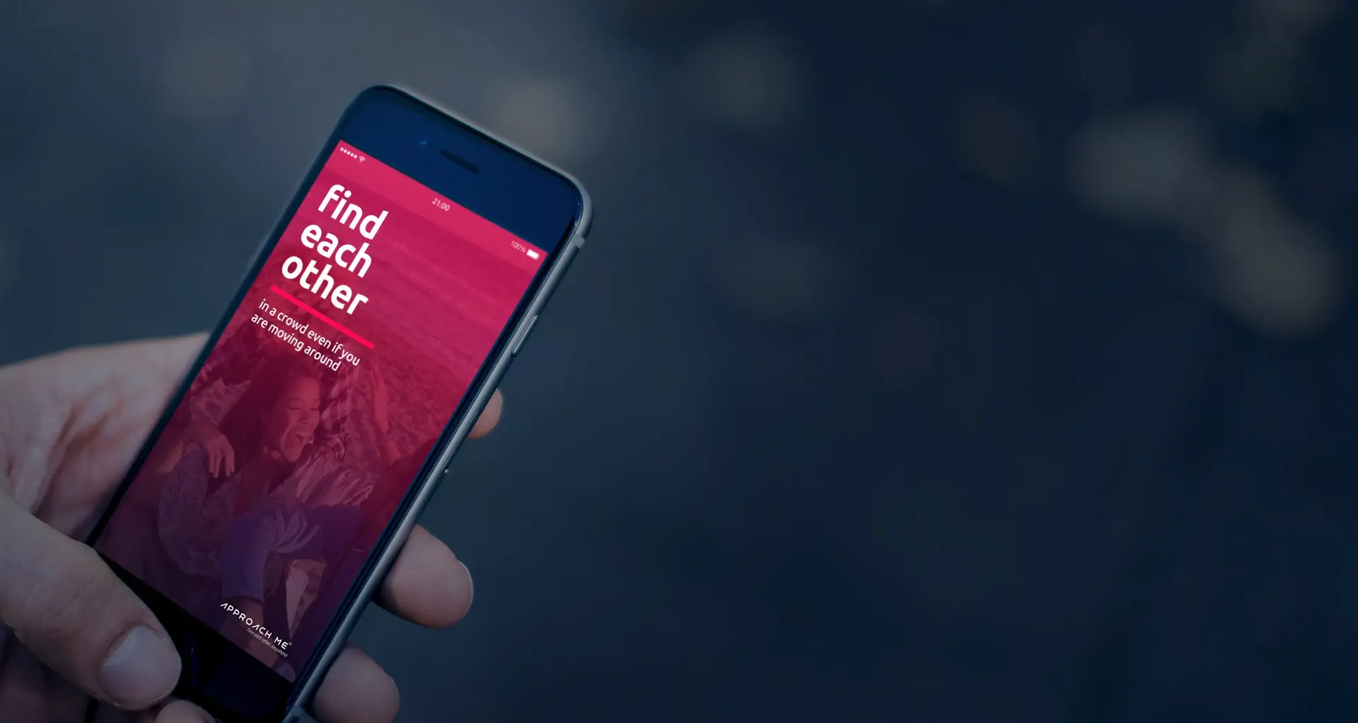 A hand holding a phone showing the ApproachMe app